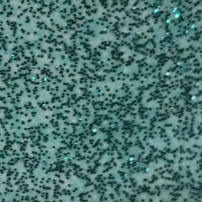 Textured surface with black specks on a light blue background