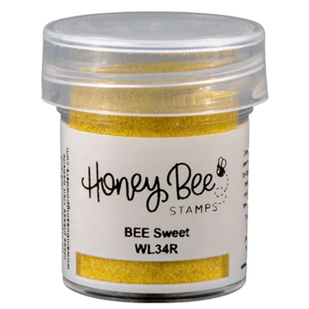 Jar of gold glitter with 'Honey Bee Stamps' label on a white background