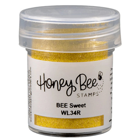 Jar of gold glitter with 'Honey Bee Stamps' label on a white background